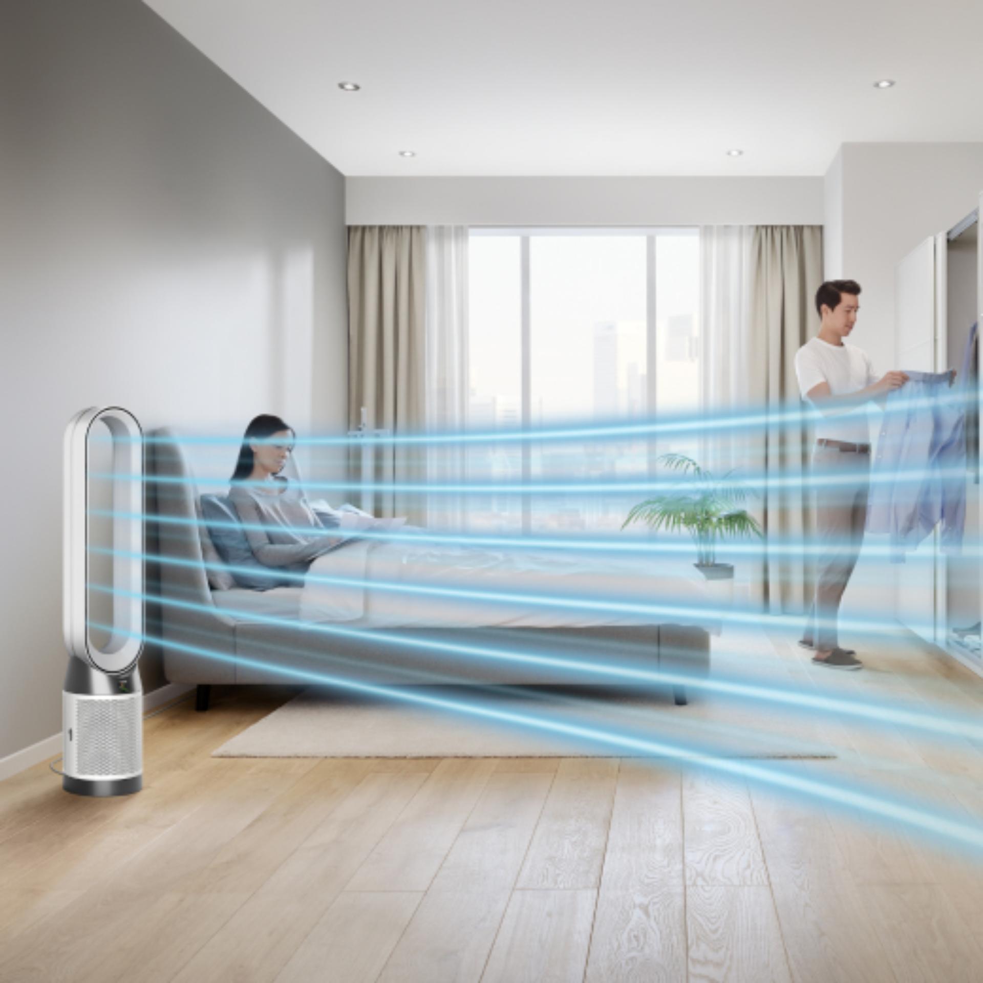 A Dyson Purifier Cool Gen1 TP10 purifying fan operates next to a person in a bed.